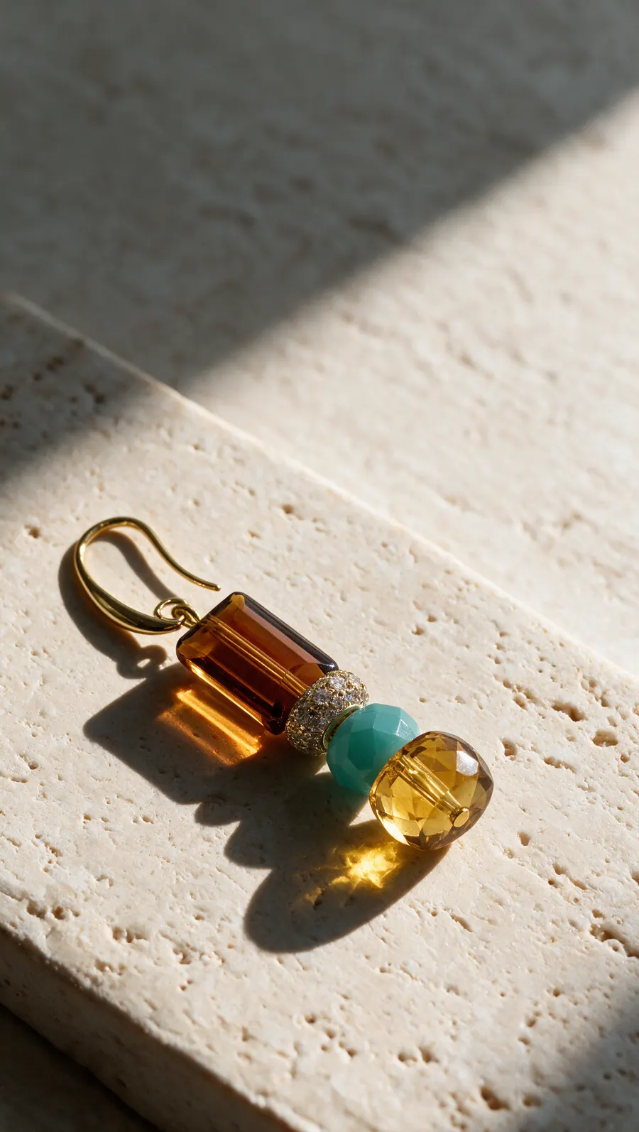 The earring on travertine in window light