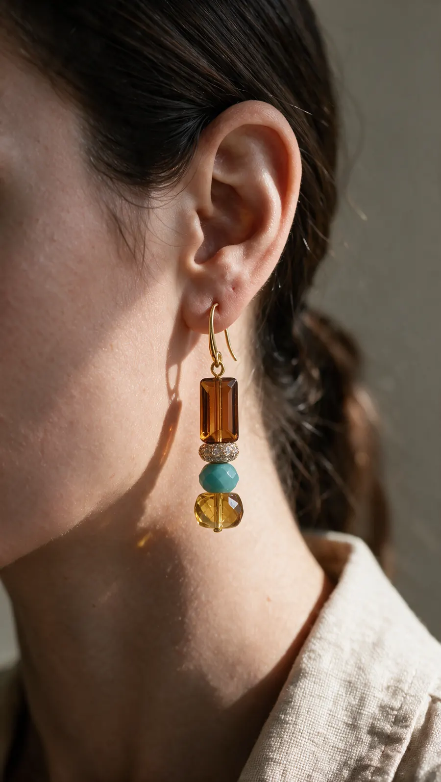 Vertical ad of the earring worn by a model